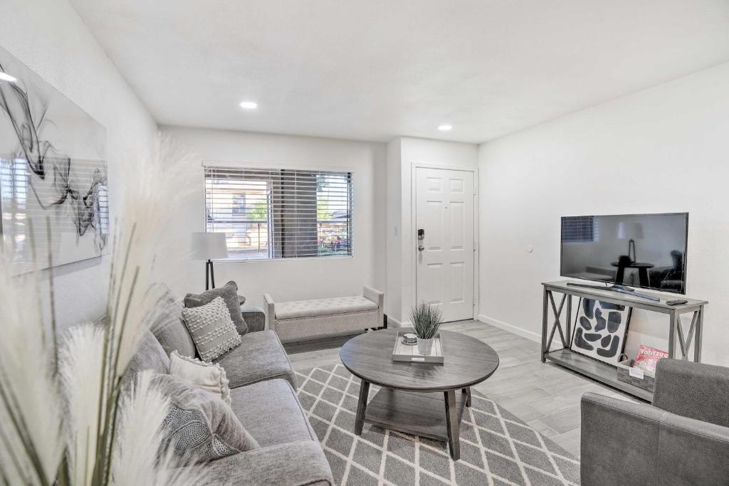 a living room with a couch and a table at Chic Phoenix Condo Pool Access, Close to Hiking in Phoenix