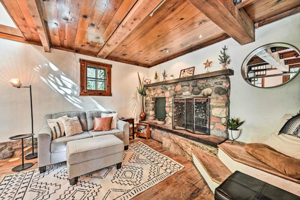 a living room with a couch and a fireplace at Peaceful Sedona Retreat with Patio and Mtn Views! in Sedona
