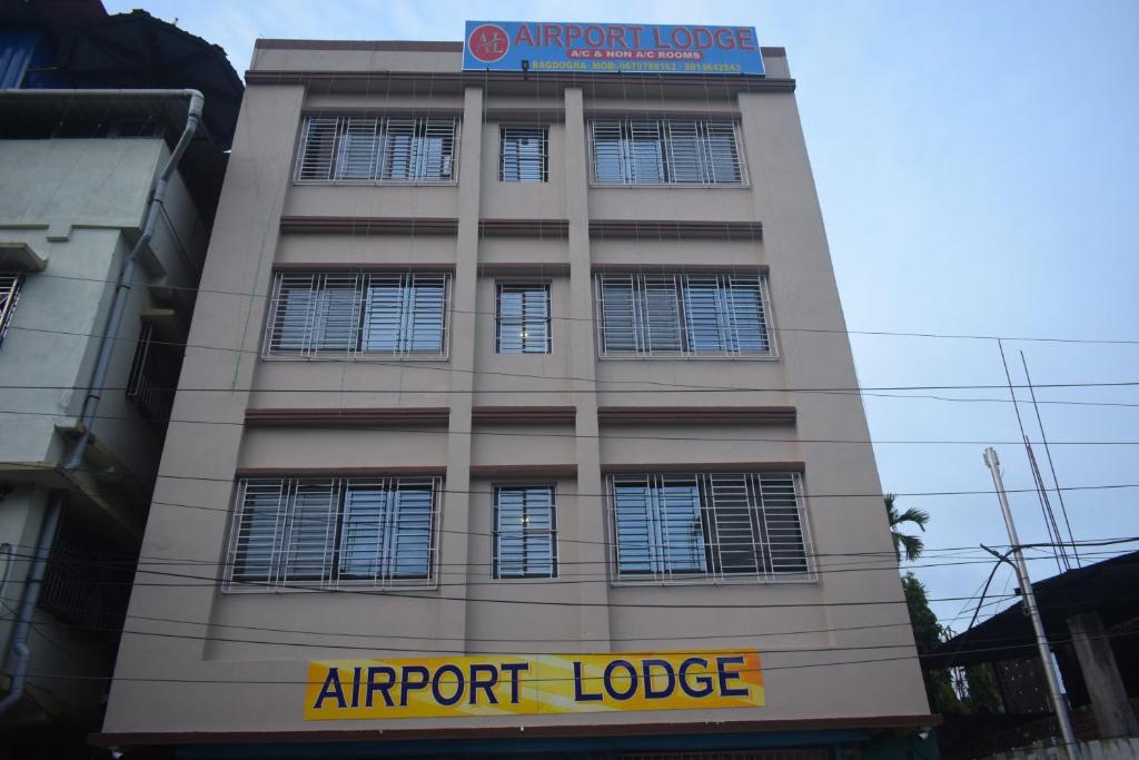 a building with a sign on top of it at Airport Lodge in Siliguri