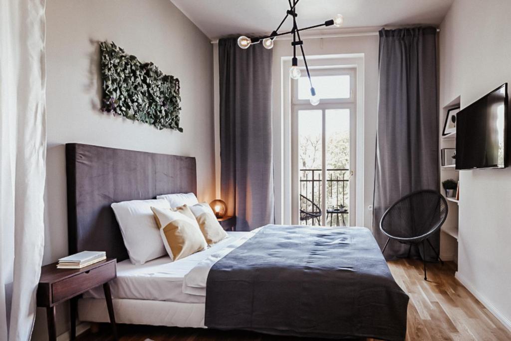 a bedroom with a large bed and a window at TurnKey I King George Square Studio in Prague