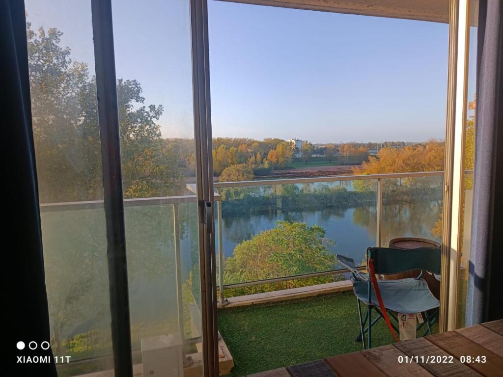 a room with a view of a lake from a balcony at Petit cocon vue sur la Loire avec Place de Parking offerte in Orléans