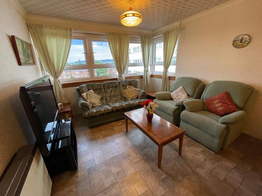 a living room with a couch and a coffee table at West End Hidden Gem - Modern 2-Bedroom Apartment with residents patio in Anniesland