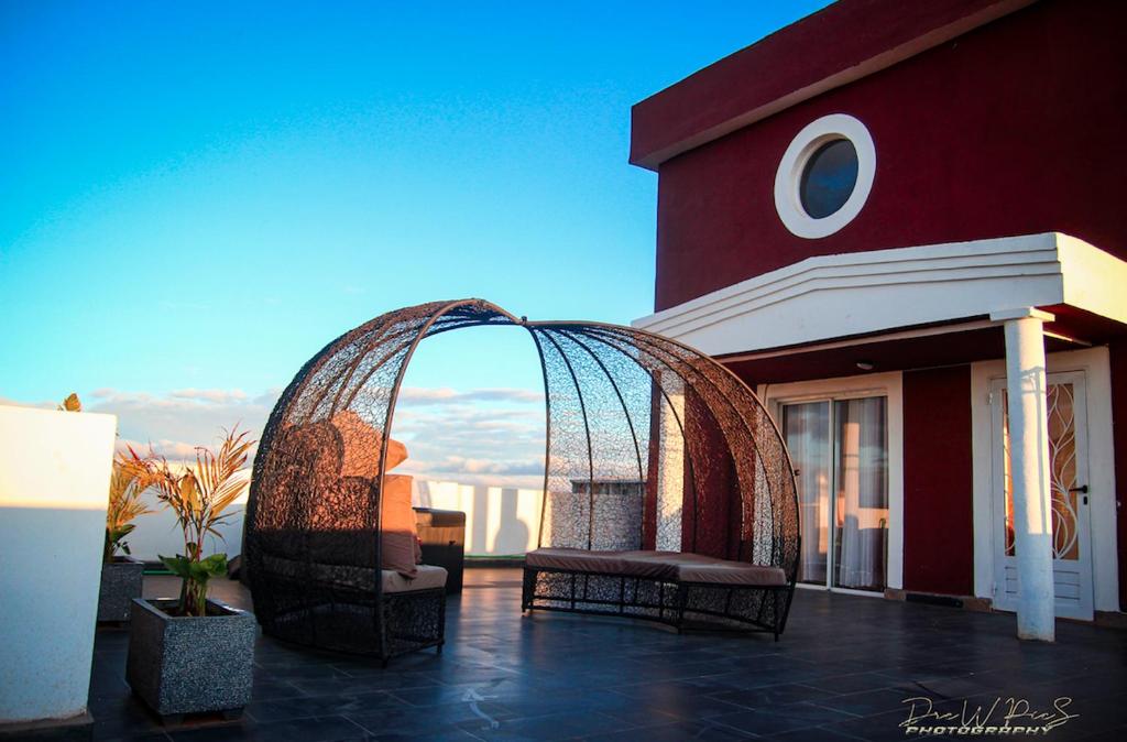 a building with a gazebo with two chairs on a patio at Or'Delice Residence in Antananarivo