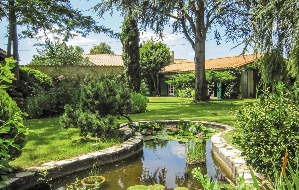 a garden with a pond and trees and a house at Amazing Home In Czac With Outdoor Swimming Pool in Marcamps