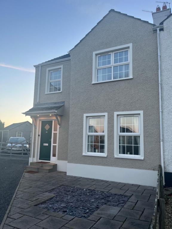 a house with a green door and a driveway at Ballycastle Best Times in Ballycastle