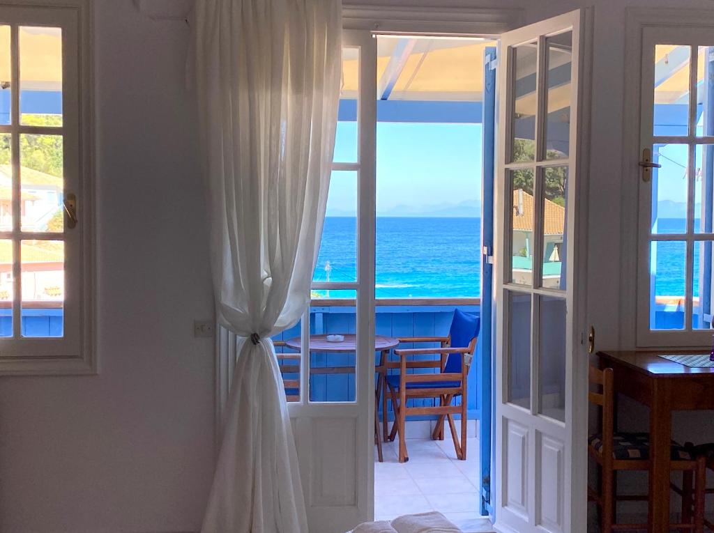 a room with a door leading to the ocean at Pantazis Studios in Agios Nikitas in Agios Nikitas