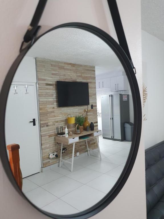 um espelho que reflecte uma cozinha com uma mesa e um frigorífico em Overport Durban Halaal Accommodation "No Alcohol Strictly Halaal No Parties" Entire Luxury Apartment, 2 Bedroom, 4 Sleeper, Self Catering, 300m from Musjid Al Hilaal em Durban