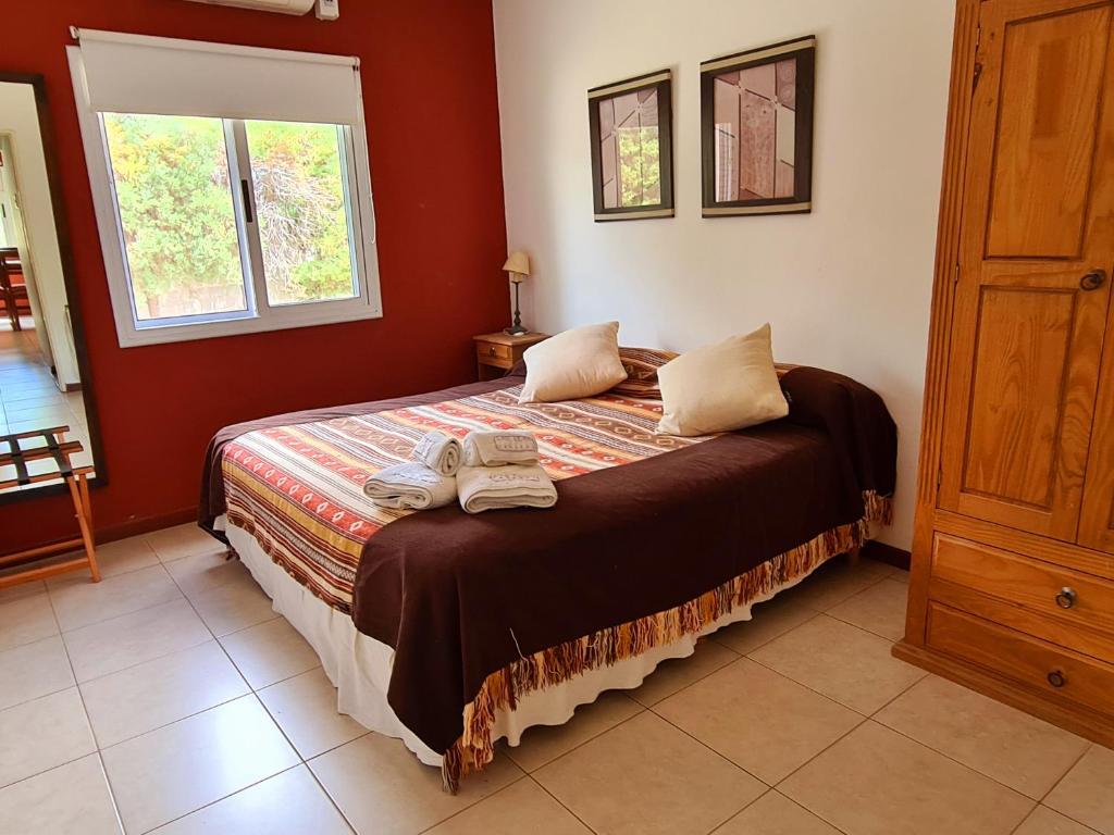 a bedroom with a bed with two towels on it at Las Lilas Cabañas in La Rioja