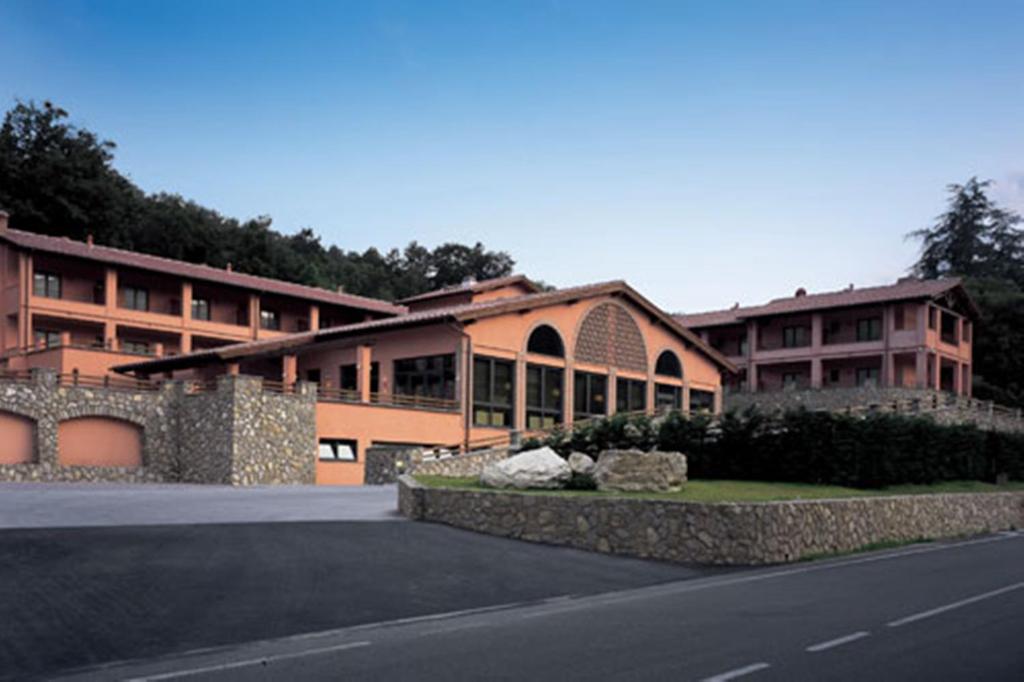 a large building with a road in front of it at Meridiana Country Hotel in Calenzano