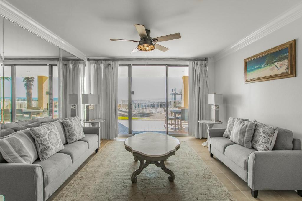 a living room with a couch and a table at Summer House 103A by Vacation Homes Collection in Orange Beach