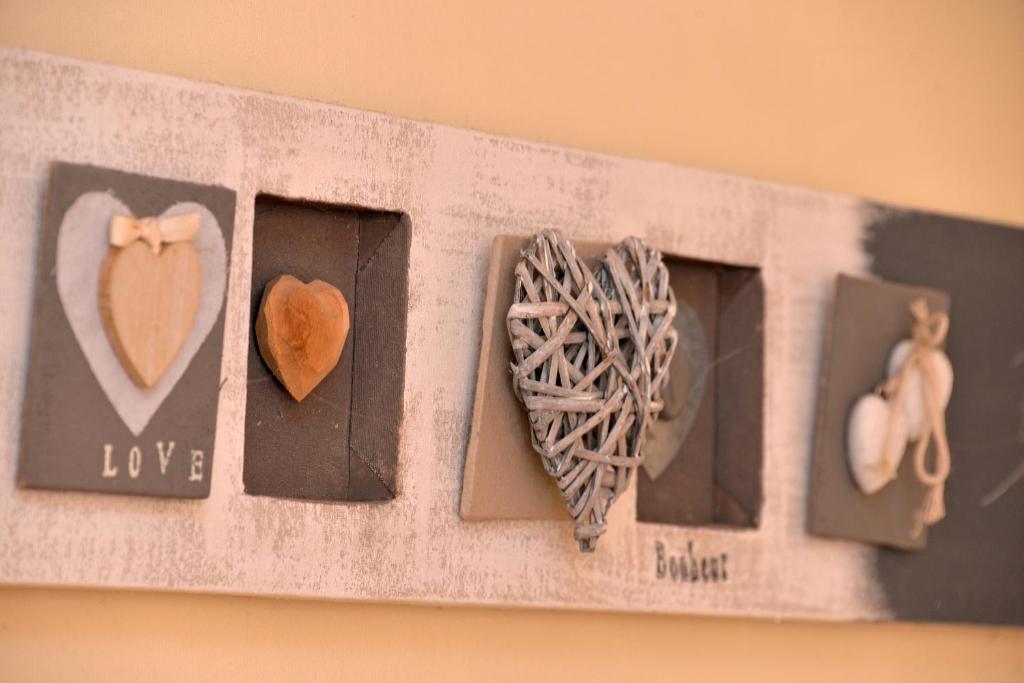a bunch of pictures of hearts on a wall at S&#39;Harzala Jaune in Bergheim