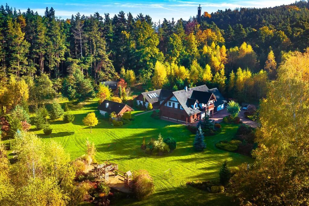 an aerial view of a house on a green field at Cottage: AŽ PO UŠI („Head over heels“) in Sloup