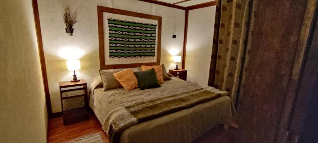 Postel nebo postele na pokoji v ubytování Refugio Los Cipreses Hotel