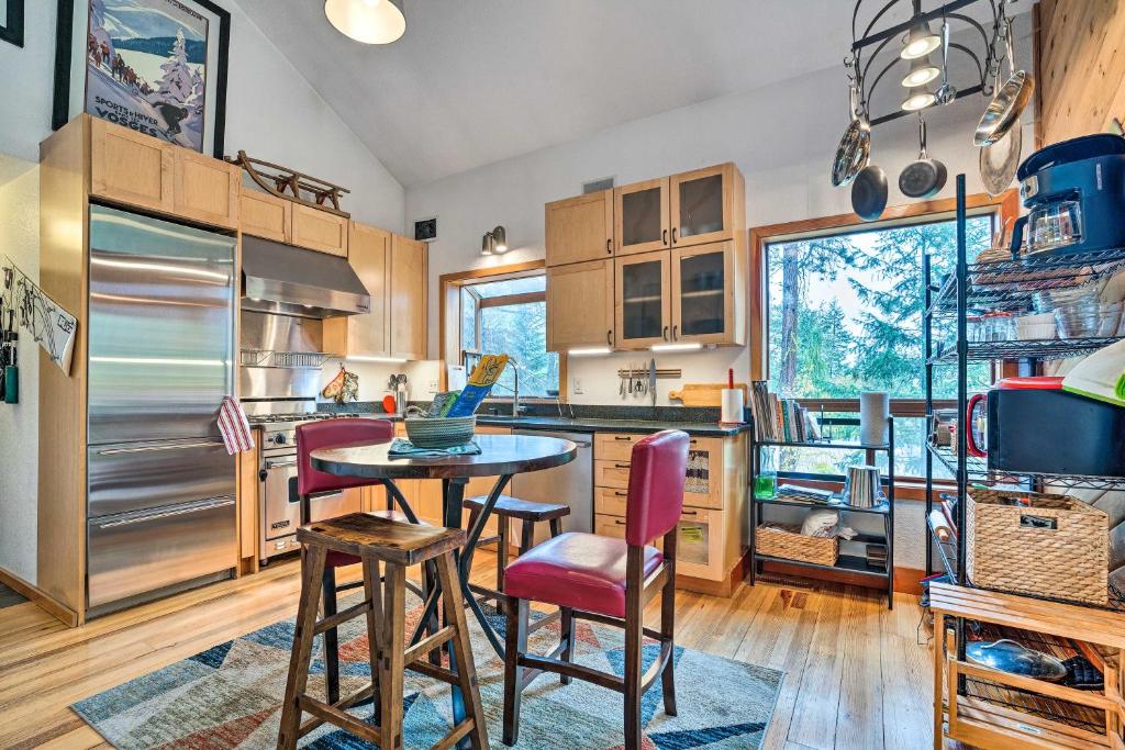 a kitchen with a table and chairs and a refrigerator at Wenatchee Retreat with Deck Less Than 4 Mi to Skiing! in Wenatchee