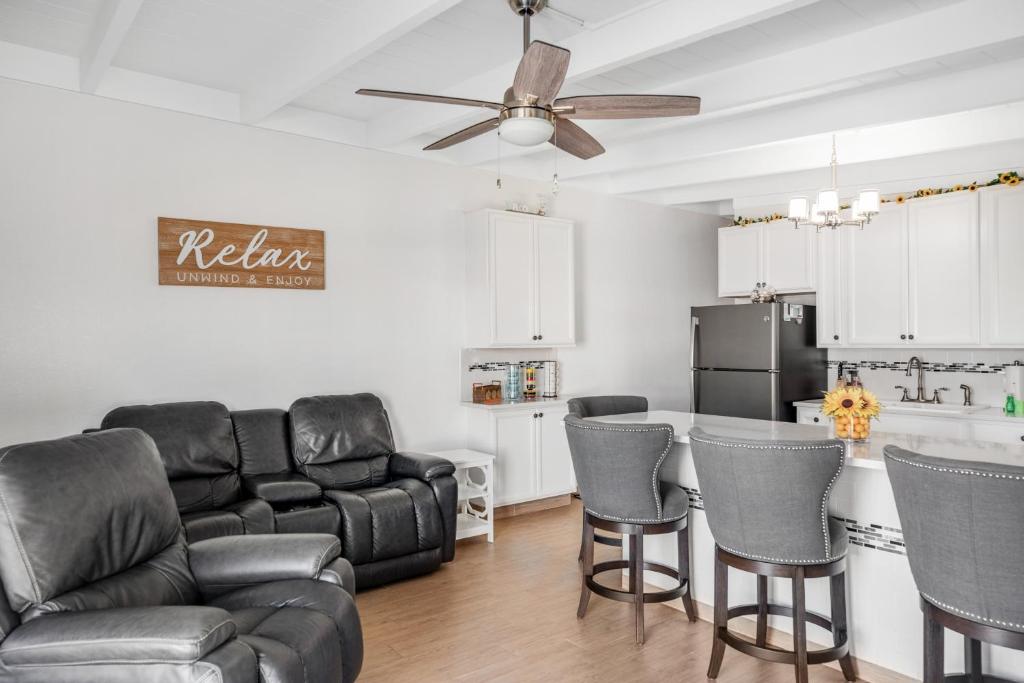 a living room with a couch and chairs and a kitchen at Relaxation Station in Key Colony Beach