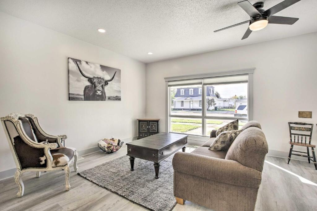 a living room with a ceiling fan and a couch and a table at Sheridan Getaway Near Dtwn, Fishing and Hiking! in Sheridan