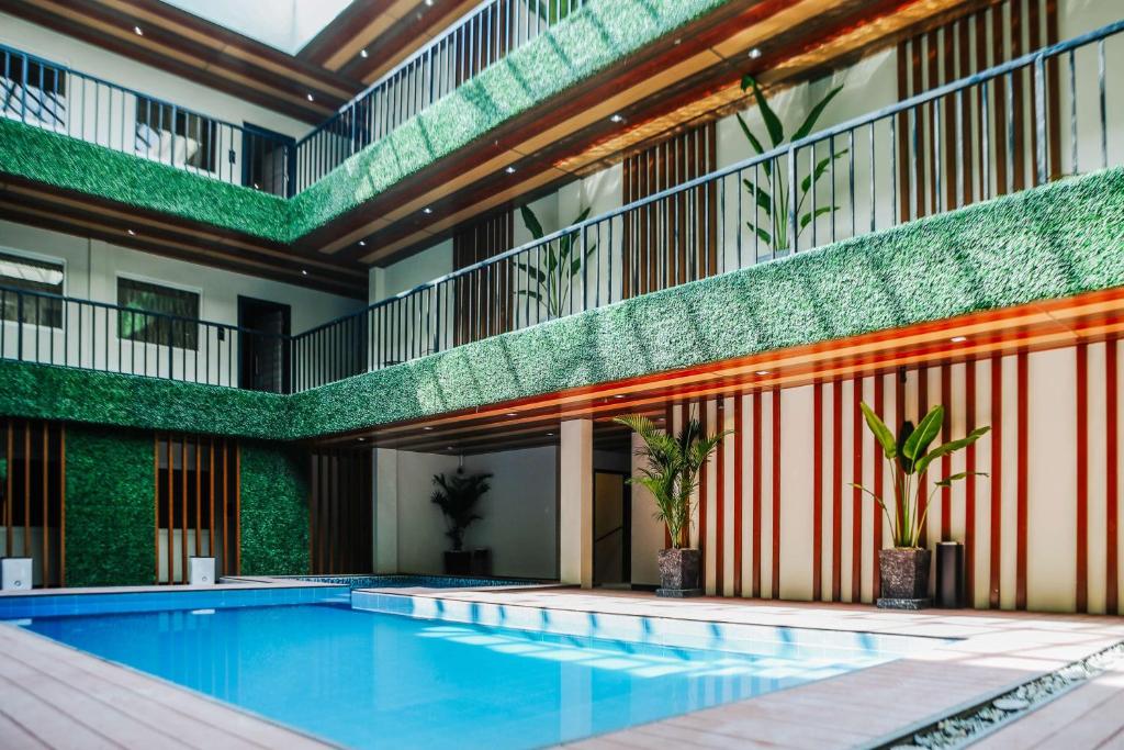an indoor swimming pool in a building with a building at SureStay Studio by Best Western Clarkview Angeles City in Angeles