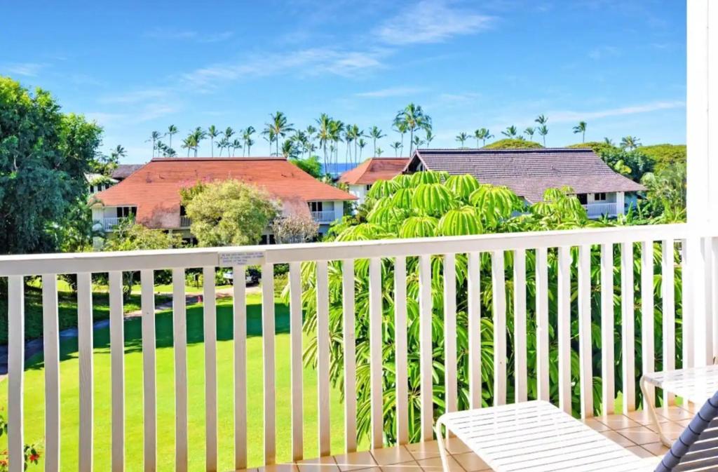 a balcony with a white fence and a yard at Kiahuna Plantation Unit 118 - 2nd Floor Expansive Views, Air Conditioning in Koloa