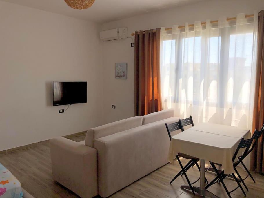 a living room with a couch and a table at Sea View Deluxe Apartment in Durrës