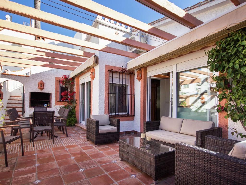 a patio with a couch and chairs and a table at Holiday Home Mijas-Costa near Beach in La Cala de Mijas