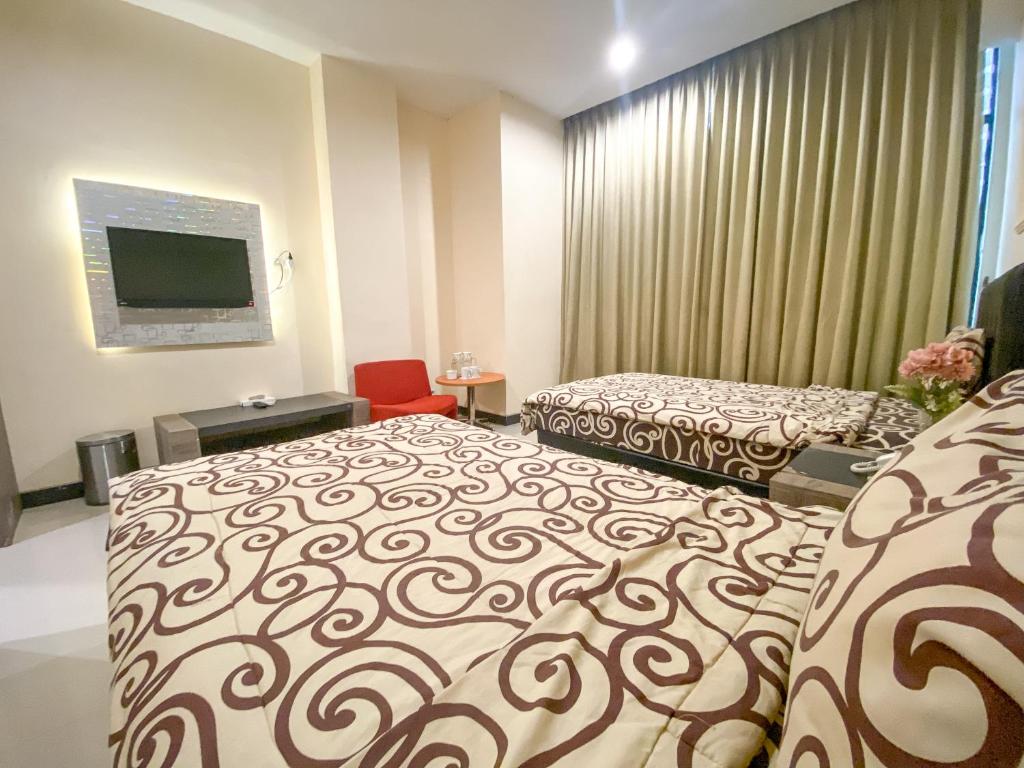 Voodi või voodid majutusasutuse UTC Hotel Semarang toas