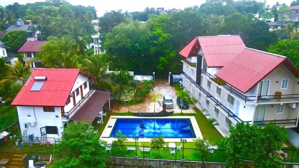 an aerial view of a house with a swimming pool at Royal Crown Residence in Talawatugoda
