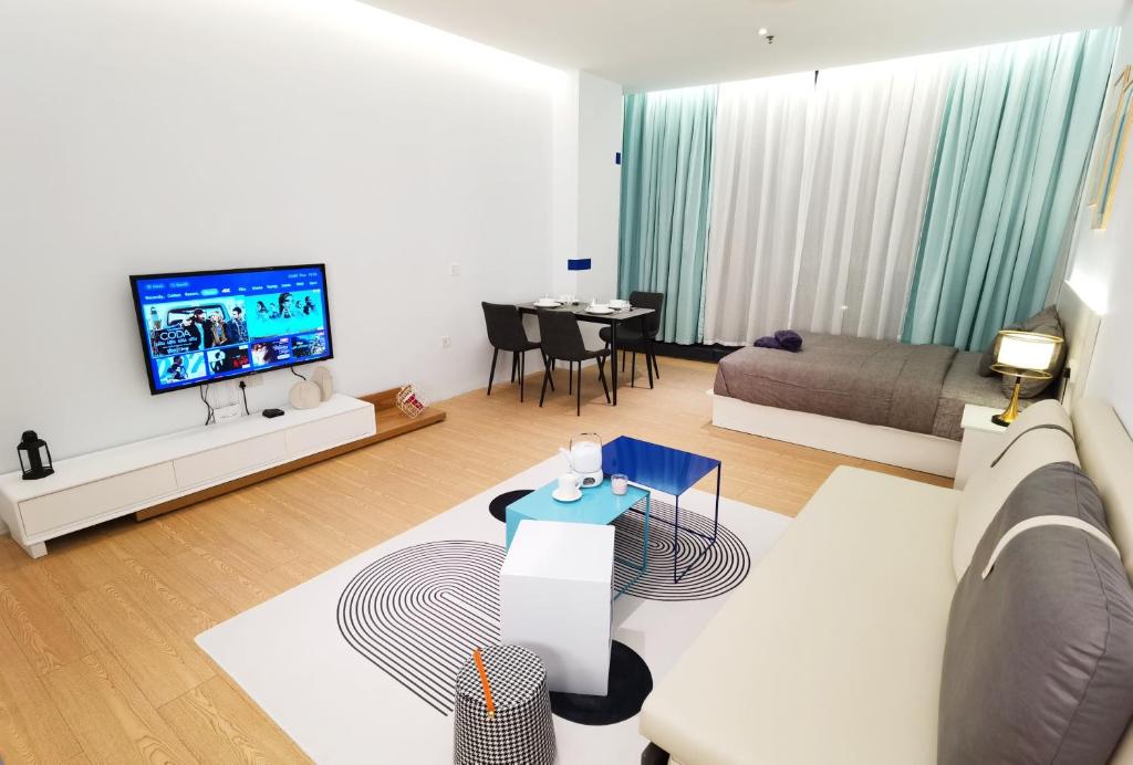 a living room with a couch and a tv at The Blueprint @ Bangsar South Mid Valley in Kuala Lumpur