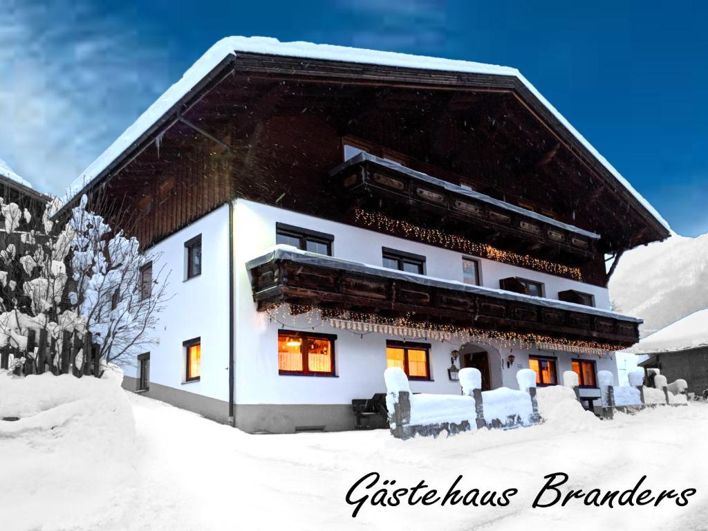 a building in the snow with snow covered at Gästehaus Branders in Namlos