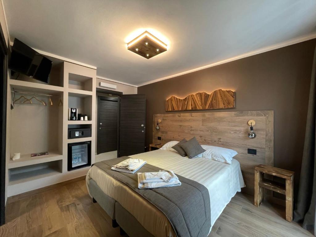 a bedroom with a large bed and a tv at Room4You in Oulx