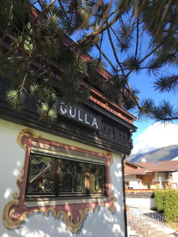 a building with a sign that reads calilla at Ferienhaus Pension Gulla in Neustift im Stubaital