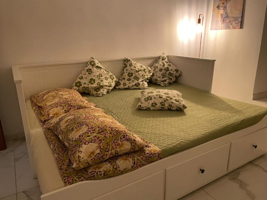 a bed with pillows on it in a room at Flowers in Rome in Rome