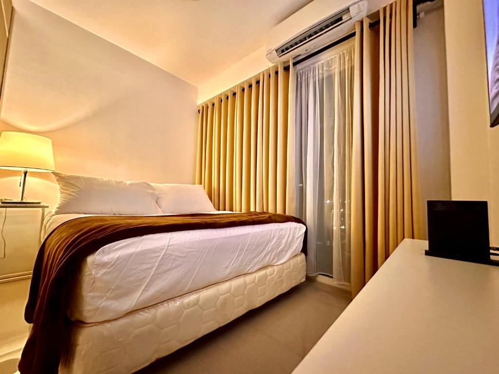 a hotel room with a bed and a window at Luxury Seaside Sunset view at the Shore Mall of Asia in Manila