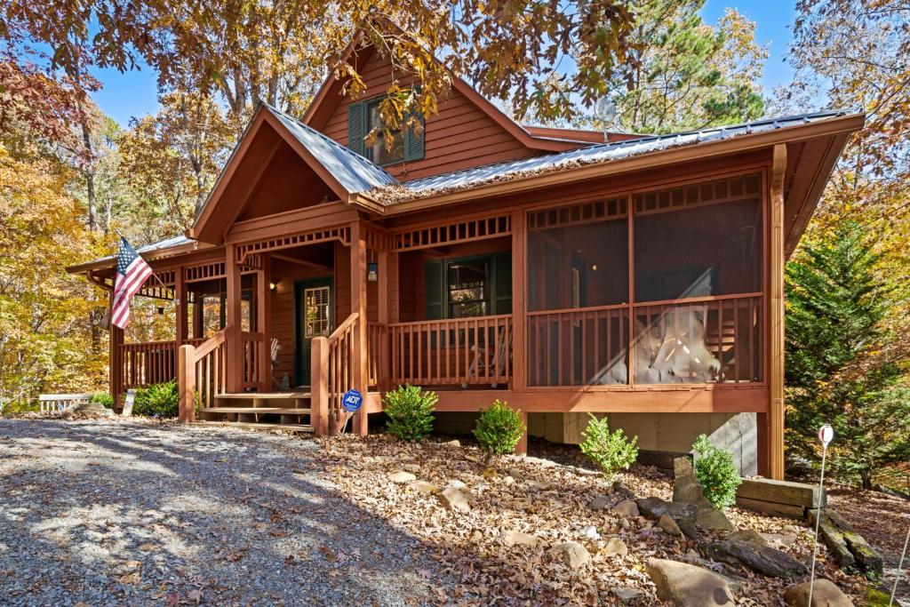 a log home with a wrap around porch at Rocky Road Retreat in Ellijay