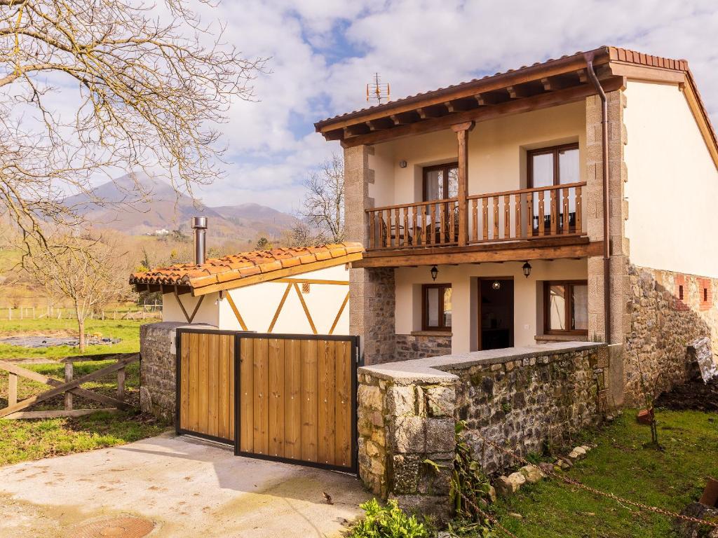 a villa with a gate in front of a house at Casa Rural Picu Llagos in Cangas de Onís