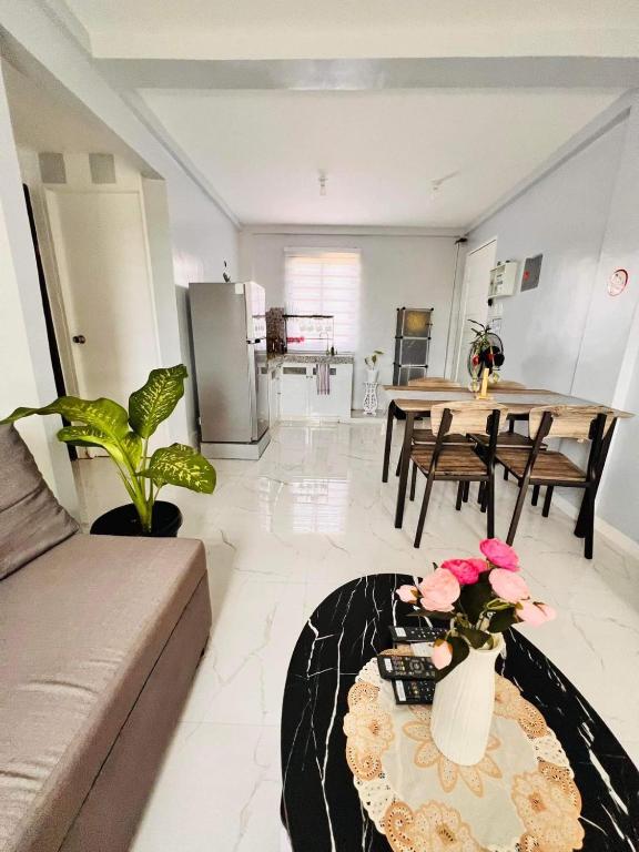 a living room with a couch and a table at Cabuhat Duco Lodge 1 in Naic