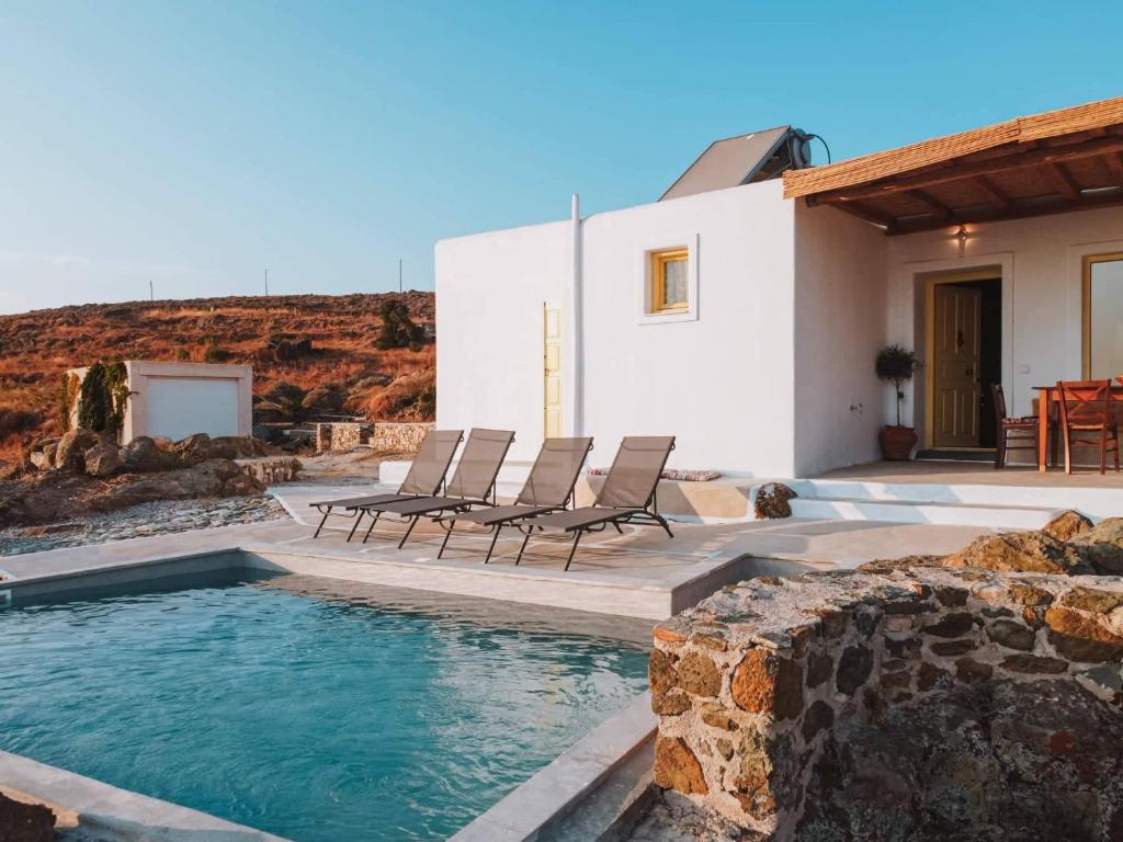 a villa with a swimming pool in front of a house at Livas Residence in Megálon Khoríon