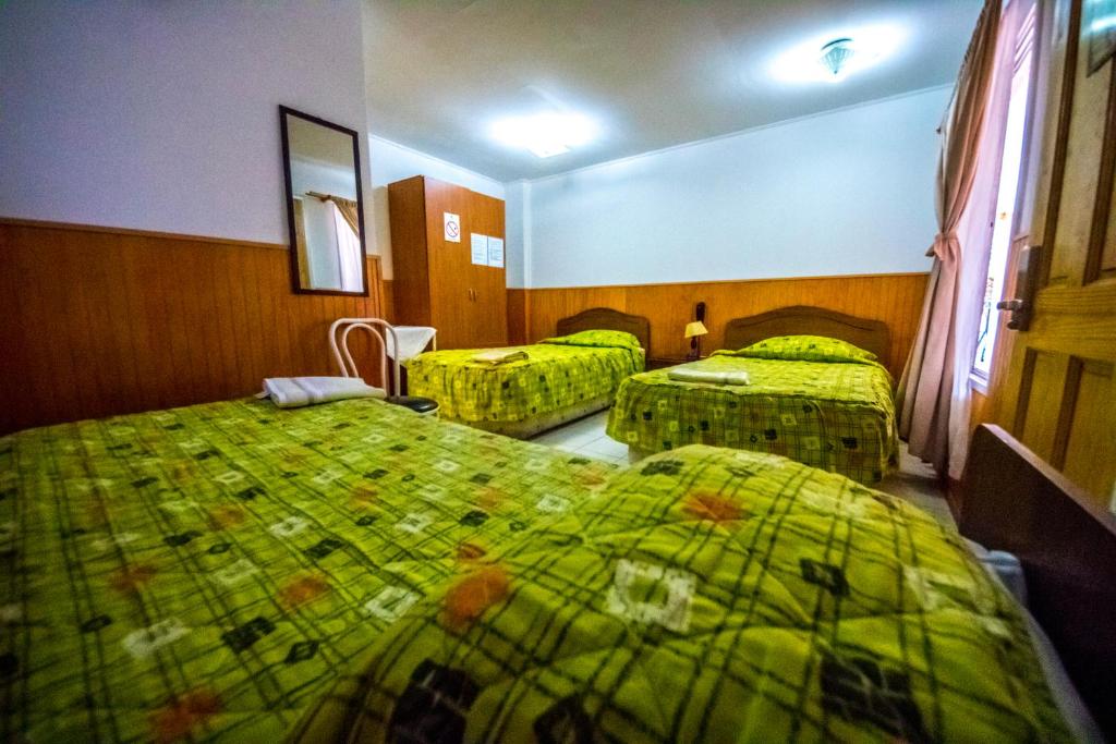 Postel nebo postele na pokoji v ubytování Hotel Montecarlo
