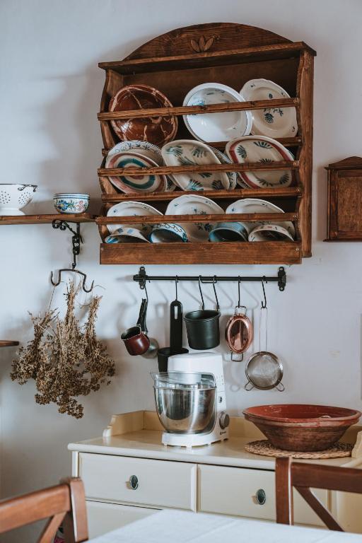 a bunch of plates and utensils hanging on a wall at Livas Residence in Megálon Khoríon