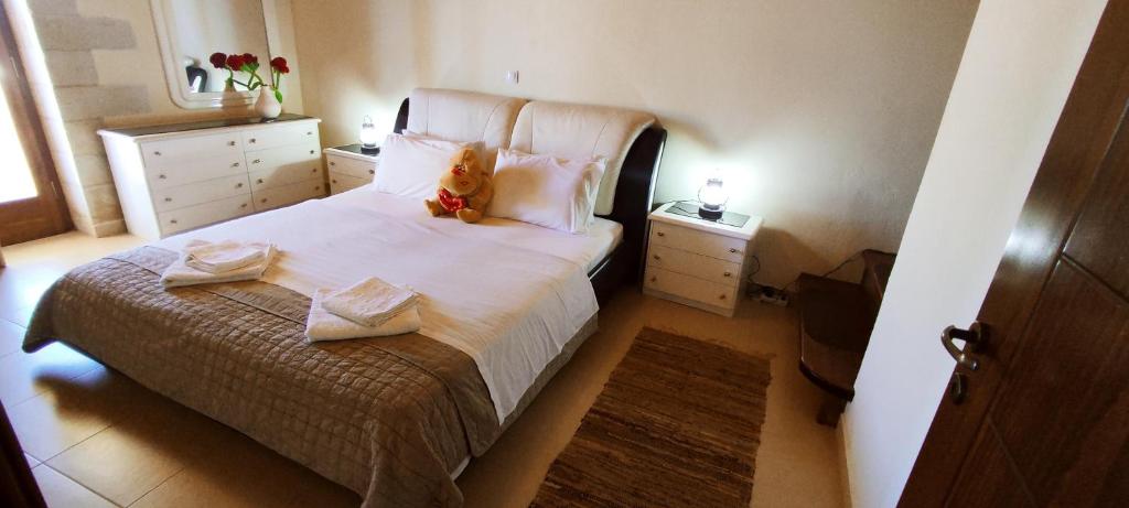 A bed or beds in a room at Vasiliki's Residence - Breathtaking View