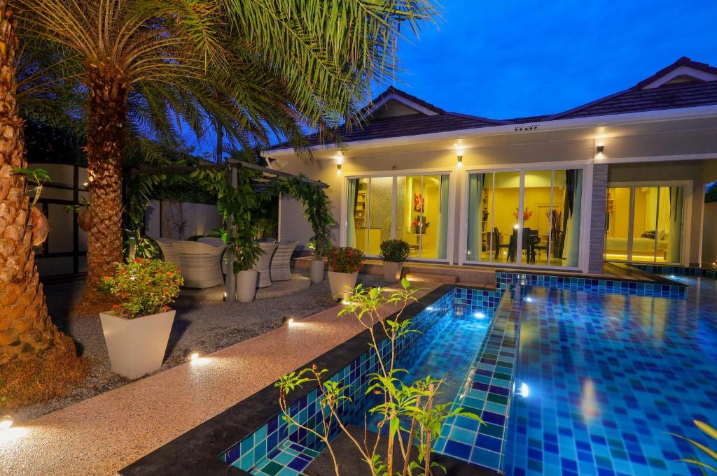 a villa with a swimming pool at night at 3 Bedroom Platinum Pool Villa Smooth as Silk in Ban Khlong Haeng