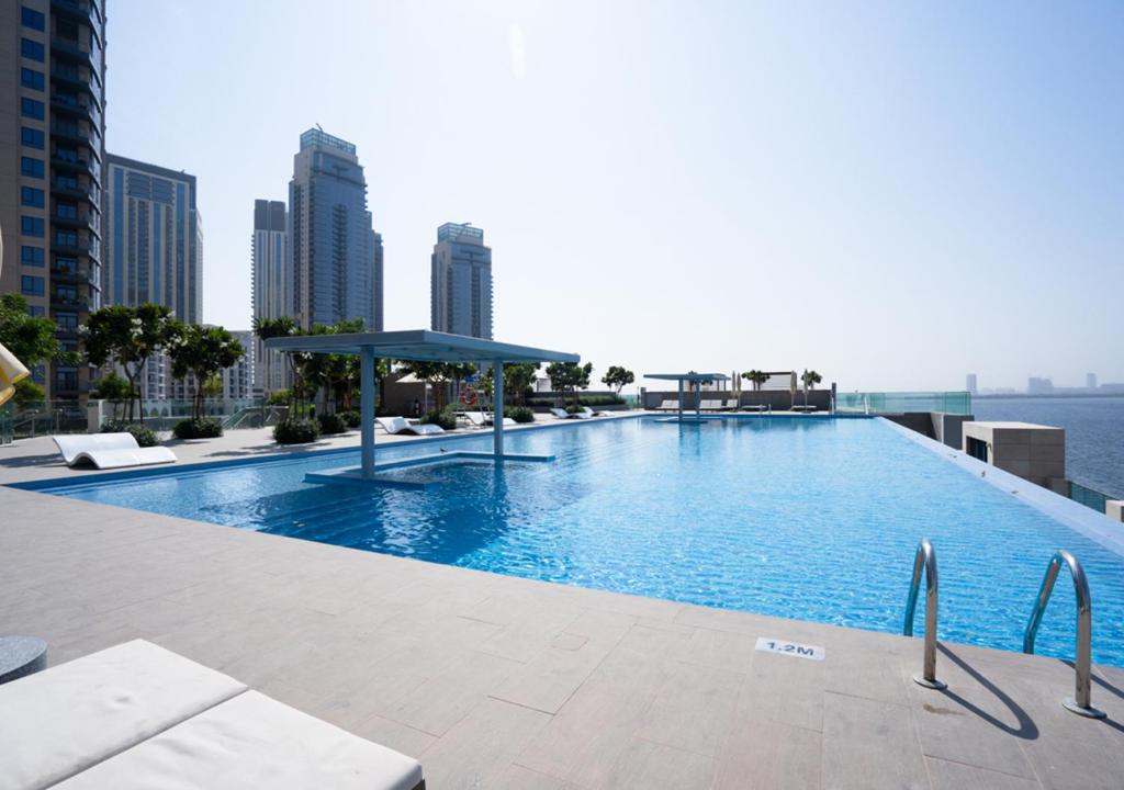 a large swimming pool on the roof of a building at Nasma Luxury Stays - The Grand, Dubai Creek Harbour in Dubai