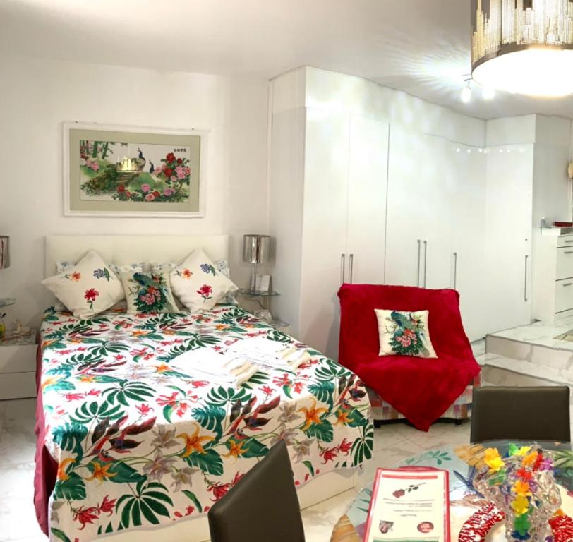a bedroom with a bed and a red pillow at Cannes Apartment close to Congress Palace, Croisette, Beaches in Cannes