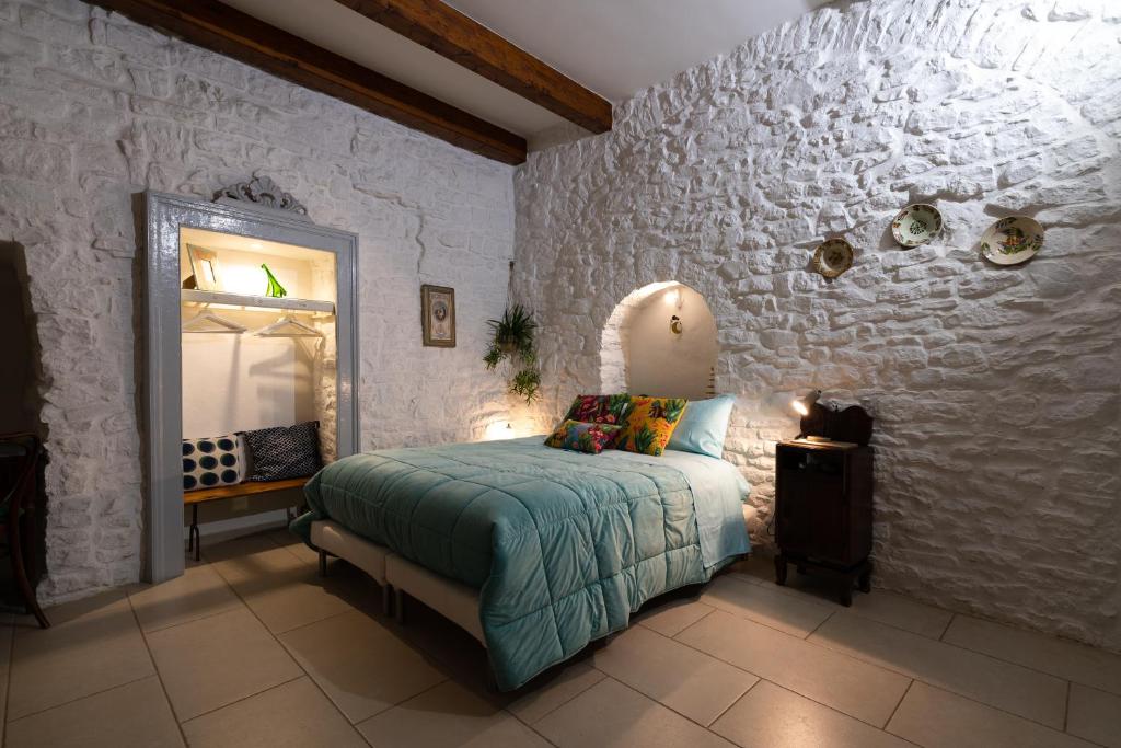 a bedroom with a bed and a mirror in it at B&B La Torretta in Bitritto