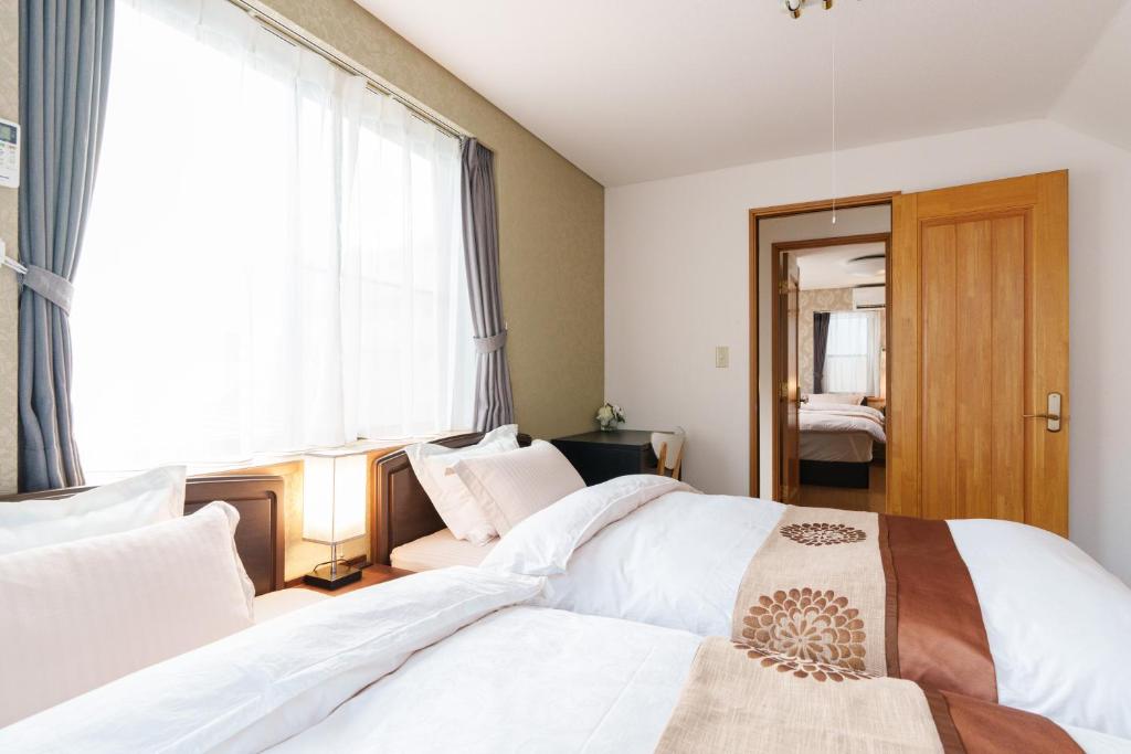 Postel nebo postele na pokoji v ubytování Luxury Guest House in Tokyo Shinjuku