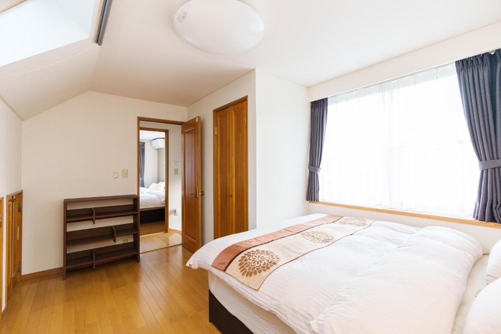 Postel nebo postele na pokoji v ubytování Luxury Guest House in Tokyo Shinjuku