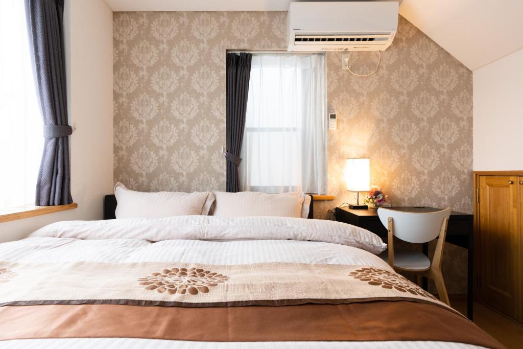 Postel nebo postele na pokoji v ubytování Luxury Guest House in Tokyo Shinjuku