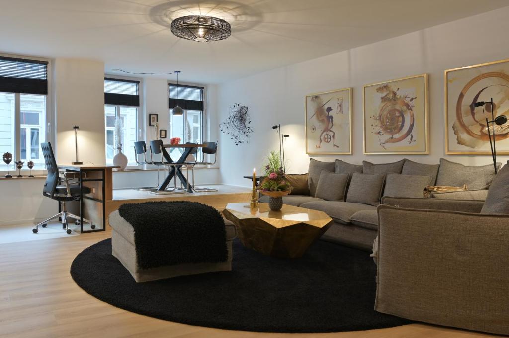 a living room with a couch and a table at Ferienwohnung STADTBLICK in Flensburg