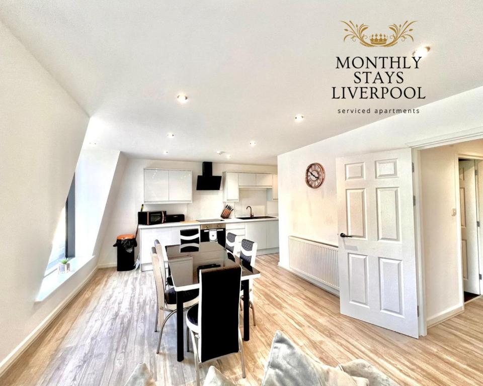 a kitchen and living room with a table and chairs at Monthly Stays Liverpool in Liverpool