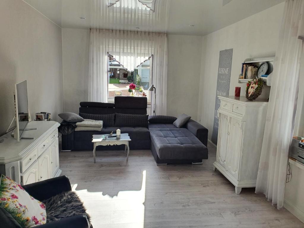 a living room with a couch and a table at Haus KanaleGrande in Haltern