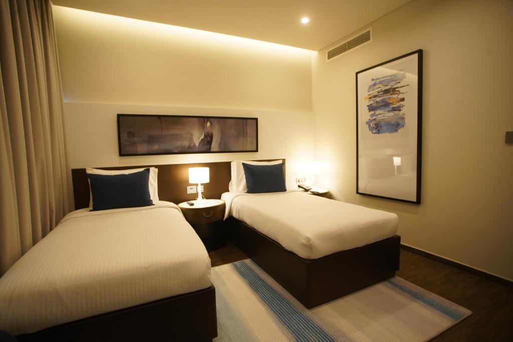 Postel nebo postele na pokoji v ubytování C - Hotel and Suites Doha
